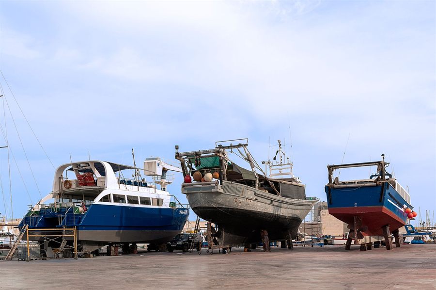 Several vessels in a dry dock for maintenance under a clear sky