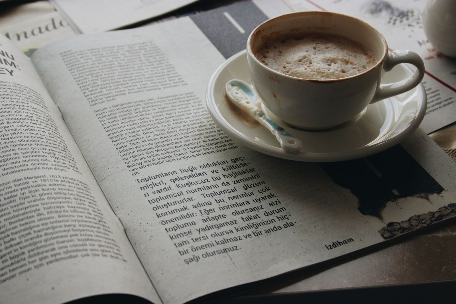 Cup of coffee on an open newspaper, a morning read of the latest cruise news
