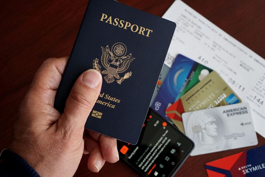 U.S. passport with cards, travel tickets and a phone on a table